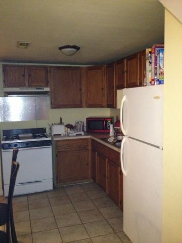 1842 South Drake Avenue Chicago, IL 60623 - Photo 5 of 25 a kitchen with a refrigerator and a stove top oven
