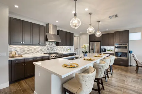 a kitchen with a dining table and chairs