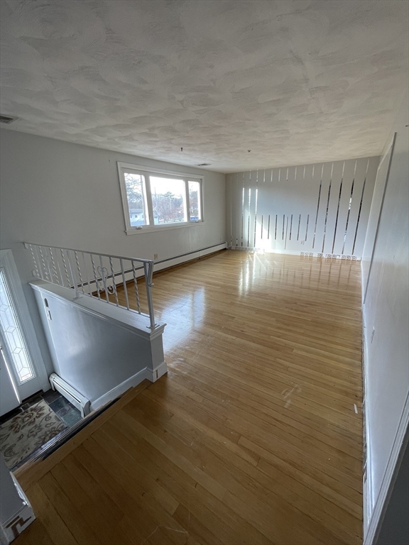 2 Eagle Rock Road, Unit 1 Randolph, MA 02368 - Photo 4 of 8 a view of a room with wooden floor staircase and windows