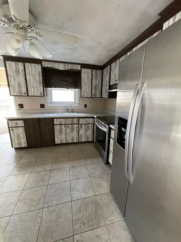 a kitchen with stainless steel appliances granite countertop a sink and a stove