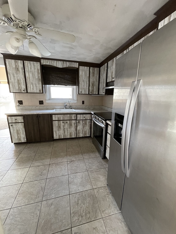 2 Eagle Rock Road, Unit 1 Randolph, MA 02368 - Photo 6 of 8 a kitchen with stainless steel appliances granite countertop a sink and a stove