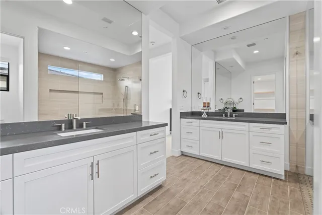 a spacious bathroom with a granite countertop sink mirror and