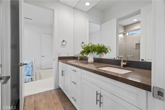 a spacious bathroom with a granite countertop sink and a mirror