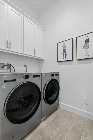 a utility room with sink dryer and washer