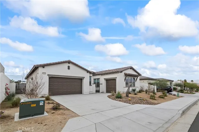 a front view of a house with yard and car parked