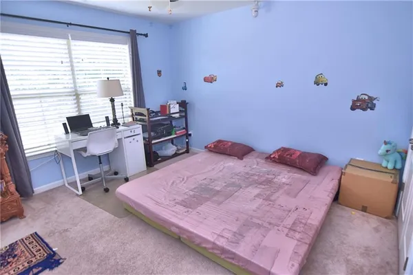 a bed sitting in a room next to a window