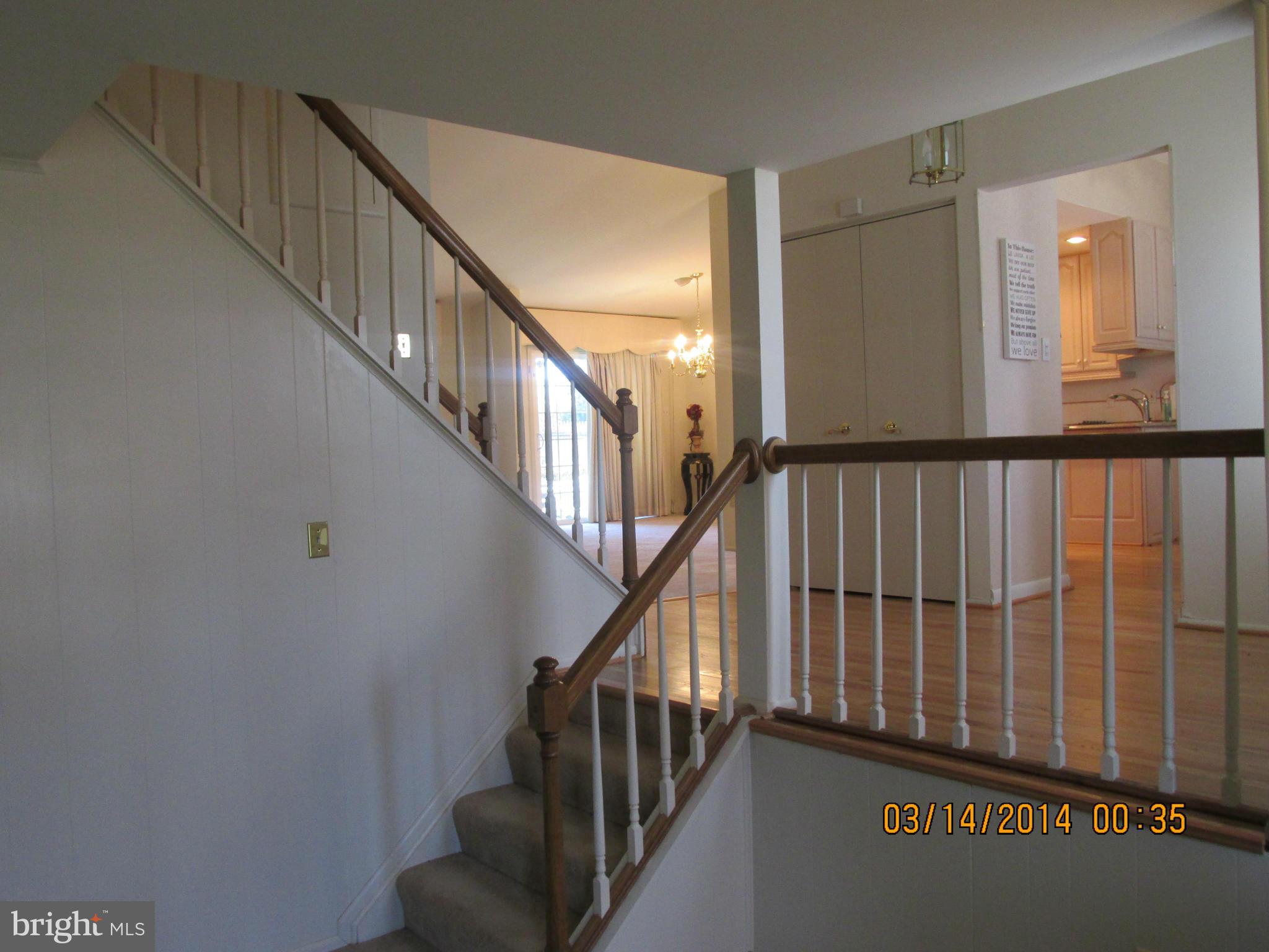 14901 Whitegate Road Silver Spring, MD 20905 - Photo 14 of 26 a view of staircase with lots of frames on wall and a window
