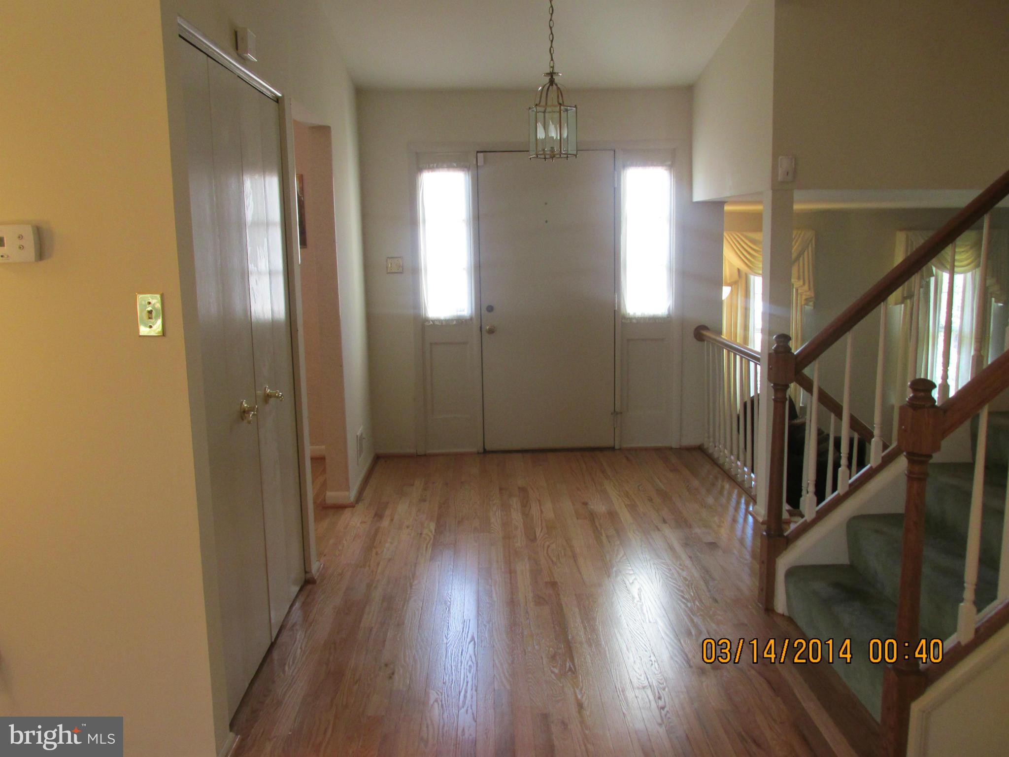 14901 Whitegate Road Silver Spring, MD 20905 - Photo 3 of 26 a view of a livingroom with wooden floor and stairs
