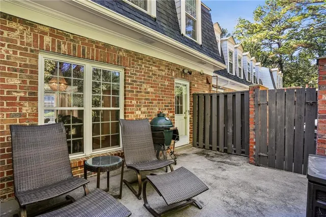 a view of a patio with a table and chairs