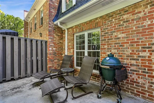 a view of a chairs and table in the back yard of the house