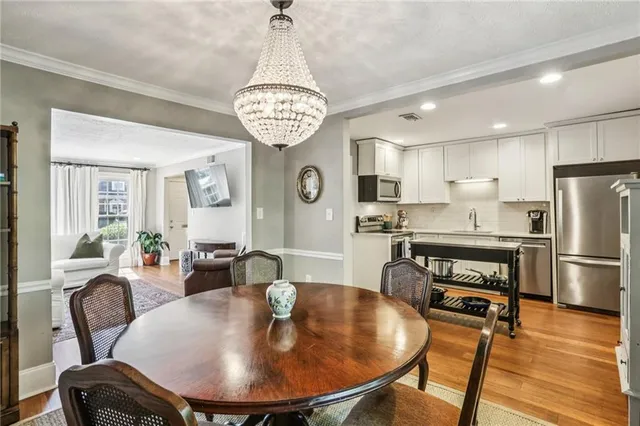 a view of a dining room with furniture wooden floor and chandelier