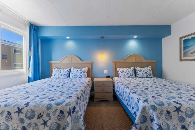 a bedroom with a bed and a lamp with window