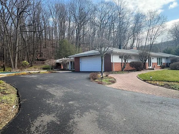 a view of a house with a yard and pathway