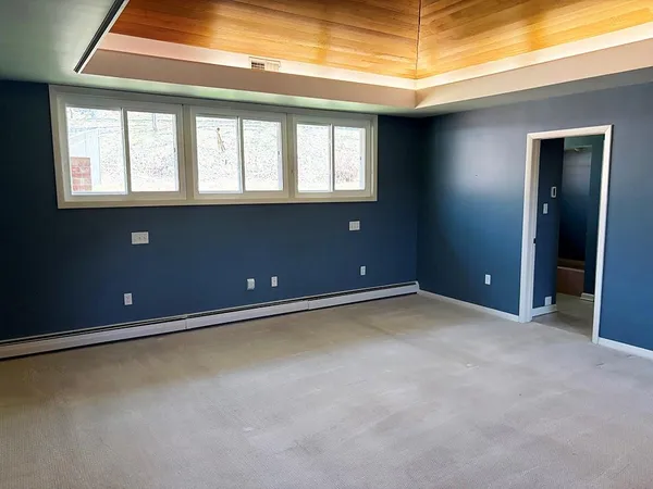 a room with a large window and chandelier