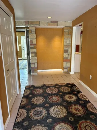 a bedroom with a bed and a rug