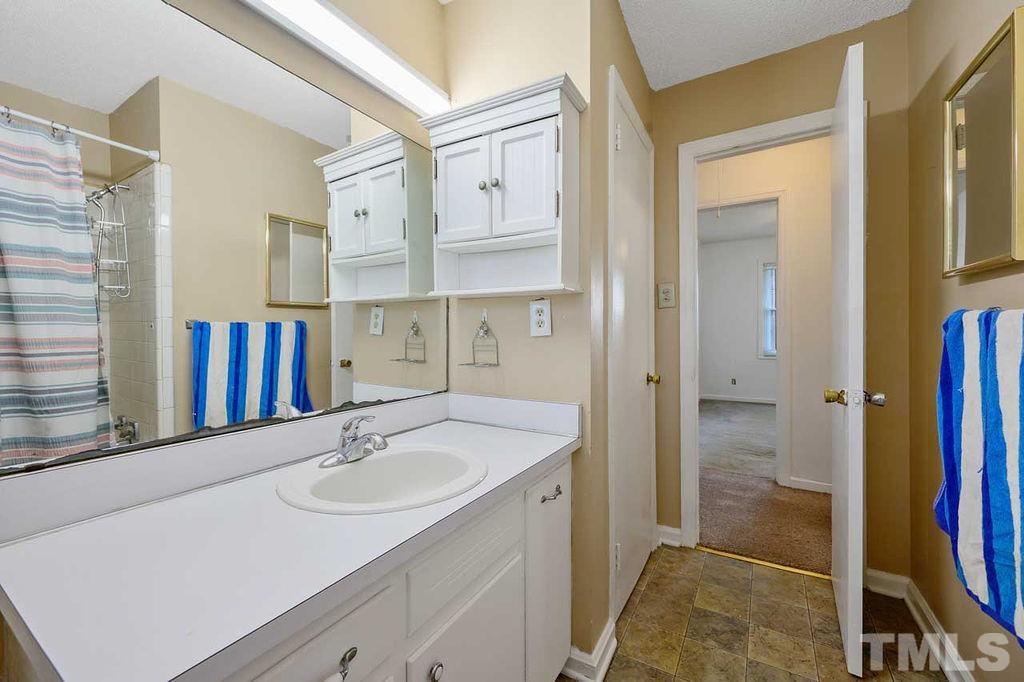 2930 Fairway Drive Raleigh, NC 27603 - Photo 15 of 24 a bathroom with a sink and a mirror