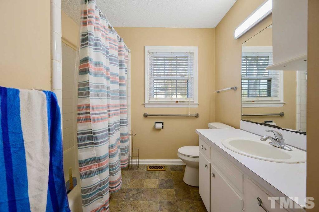 2930 Fairway Drive Raleigh, NC 27603 - Photo 16 of 24 a bathroom with a sink toilet and shower