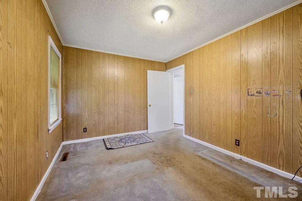 2930 Fairway Drive Raleigh, NC 27603 - Photo 18 of 24 a view of room with wooden walls