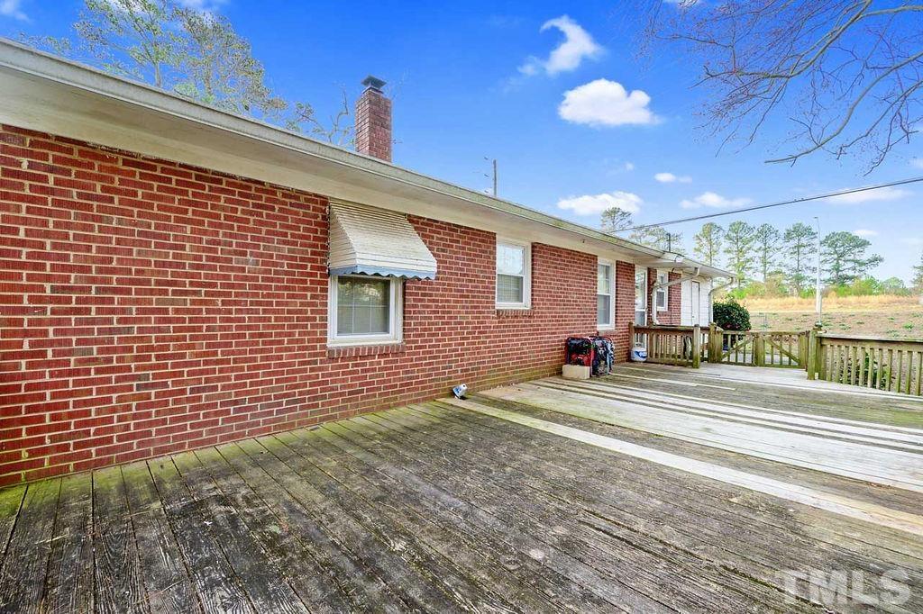 2930 Fairway Drive Raleigh, NC 27603 - Photo 20 of 24 a view of a patio with a table and chairs and floor to ceiling window