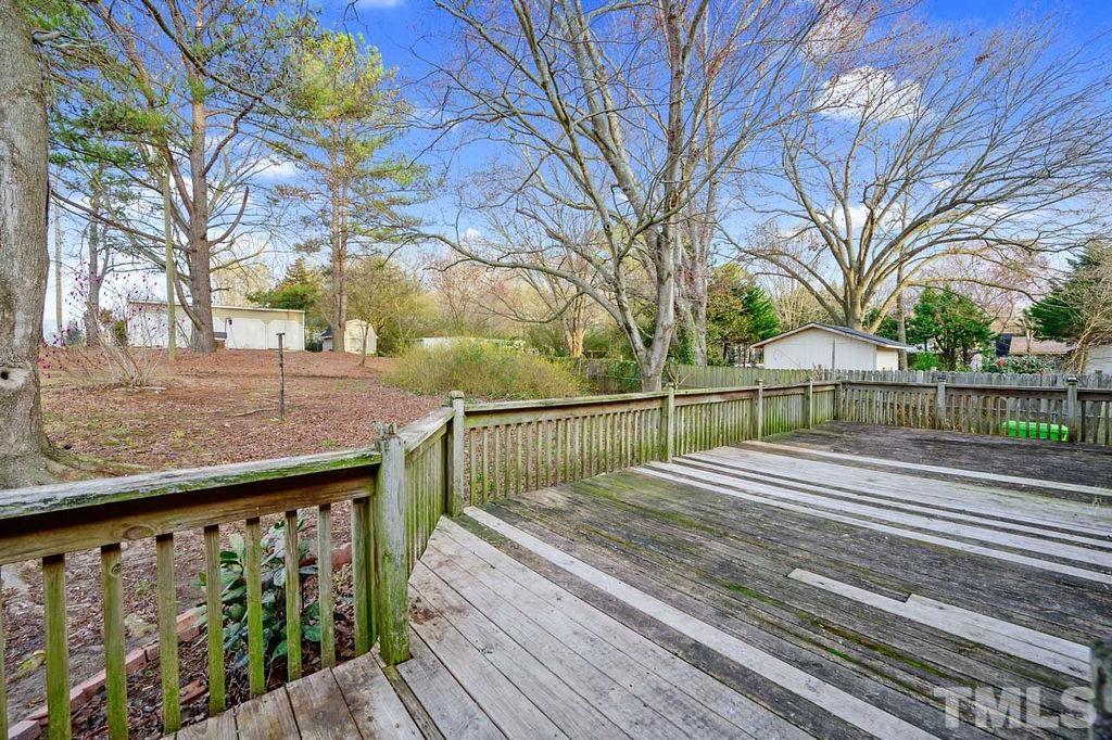 2930 Fairway Drive Raleigh, NC 27603 - Photo 21 of 24 a view of a wooden deck with a large trees