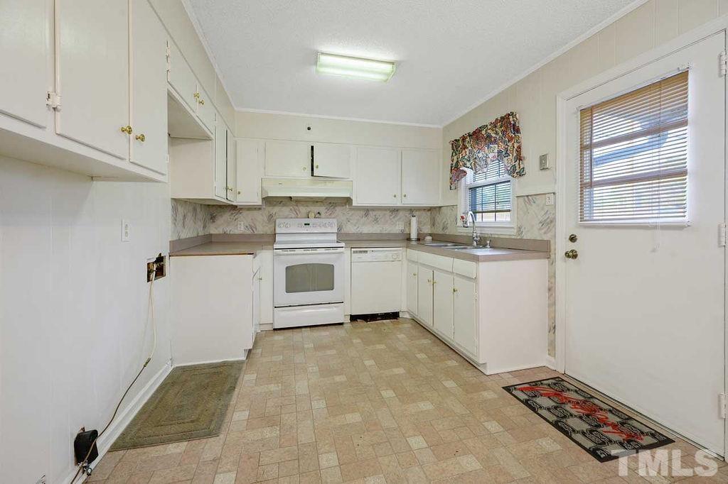 2930 Fairway Drive Raleigh, NC 27603 - Photo 9 of 24 a kitchen with stainless steel appliances granite countertop a stove a sink and white cabinets