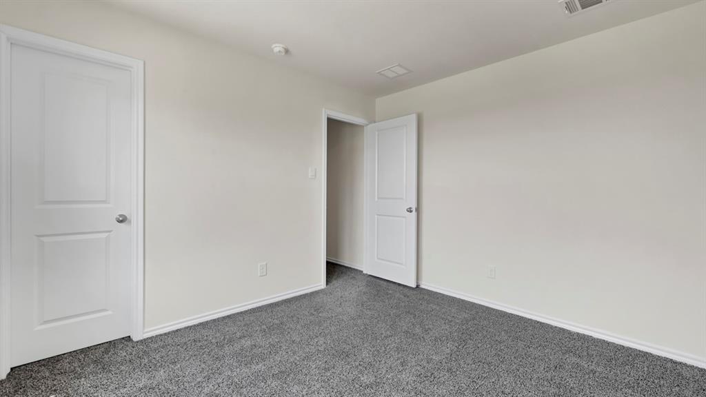 4012 Ripplewood Drive Lindale, TX 75771 - Photo 9 of 37 Room featuring light gray wall paint, white baseboards, and gray carpet flooring