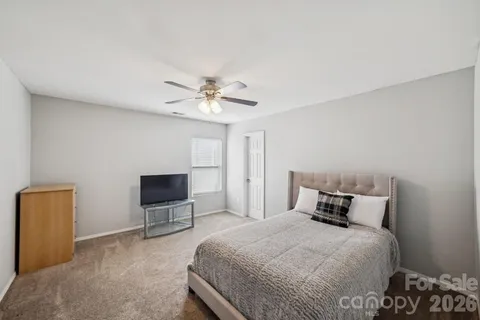 a bedroom with a bed and a chair