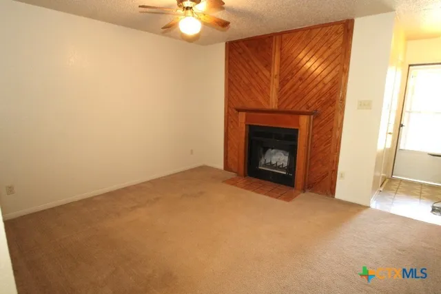 a view of an empty room with a fireplace