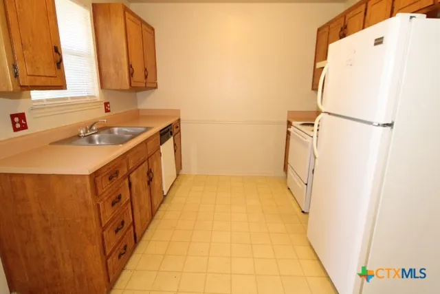 a bathroom with a sink a mirror and a shower