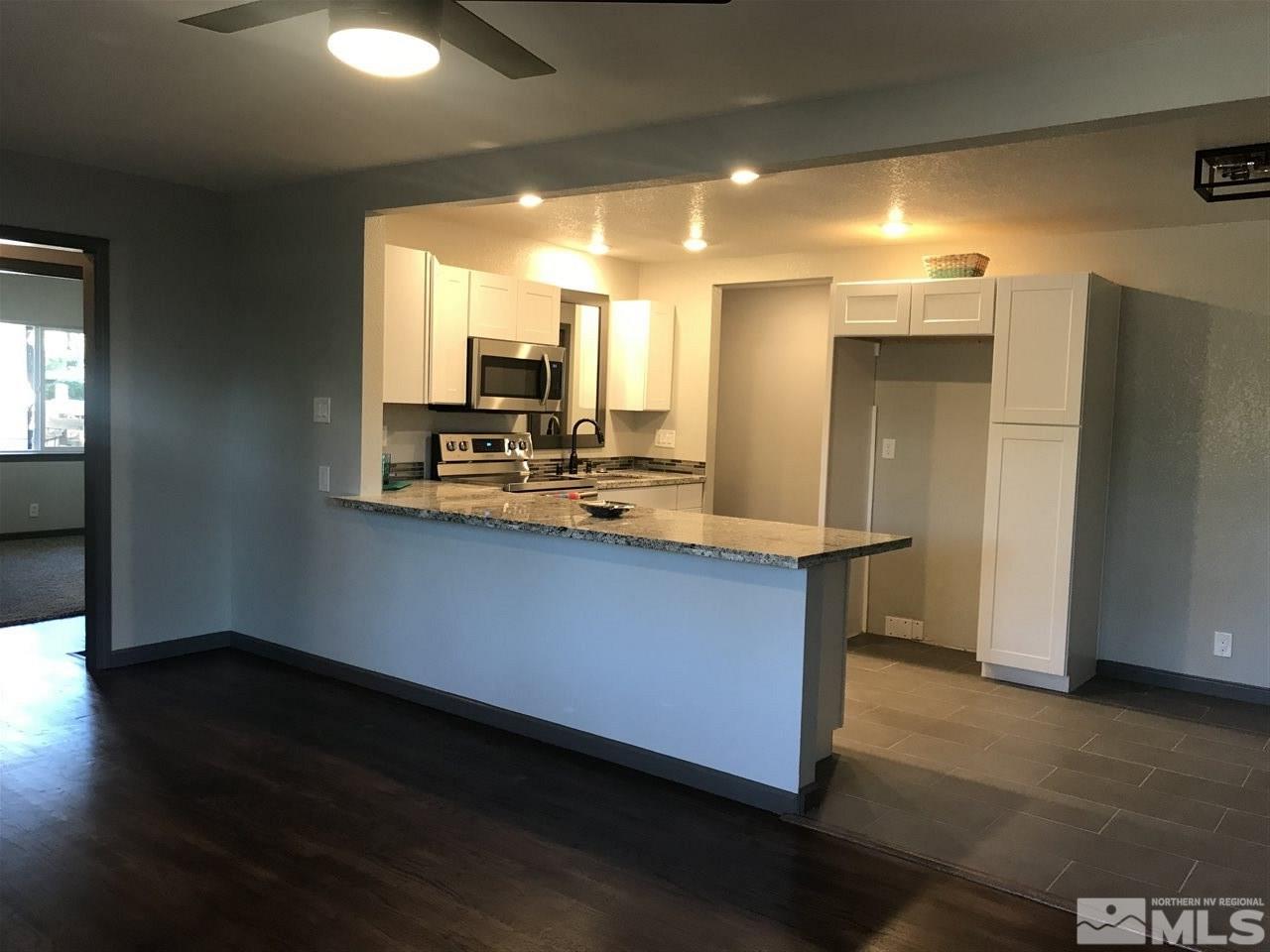 1685 Grandview Avenue Reno, NV 89503 - Photo 4 of 25 a kitchen with kitchen island a sink appliances and cabinets