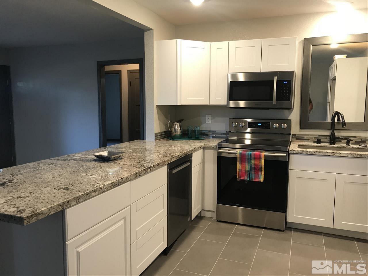 1685 Grandview Avenue Reno, NV 89503 - Photo 6 of 25 a kitchen with stainless steel appliances granite countertop a stove a sink and a microwave