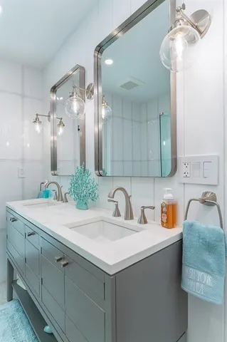 a bedroom with a bed a flat screen tv and a mirror