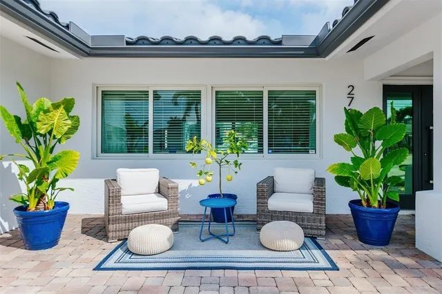 a front view of multi story residential apartment building with yard and green space