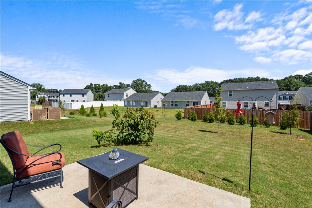 115 Queens Mill Court Pendleton, SC 29670 - Photo 27 of 32 A concrete patio overlooks the manicured lawn of a spacious, level backyard.