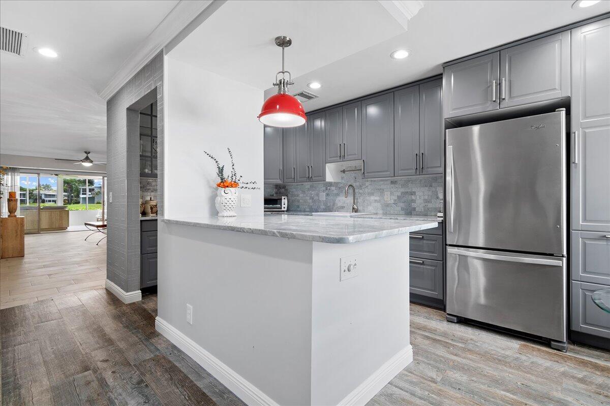 a kitchen with kitchen island a counter space a sink appliances and cabinets