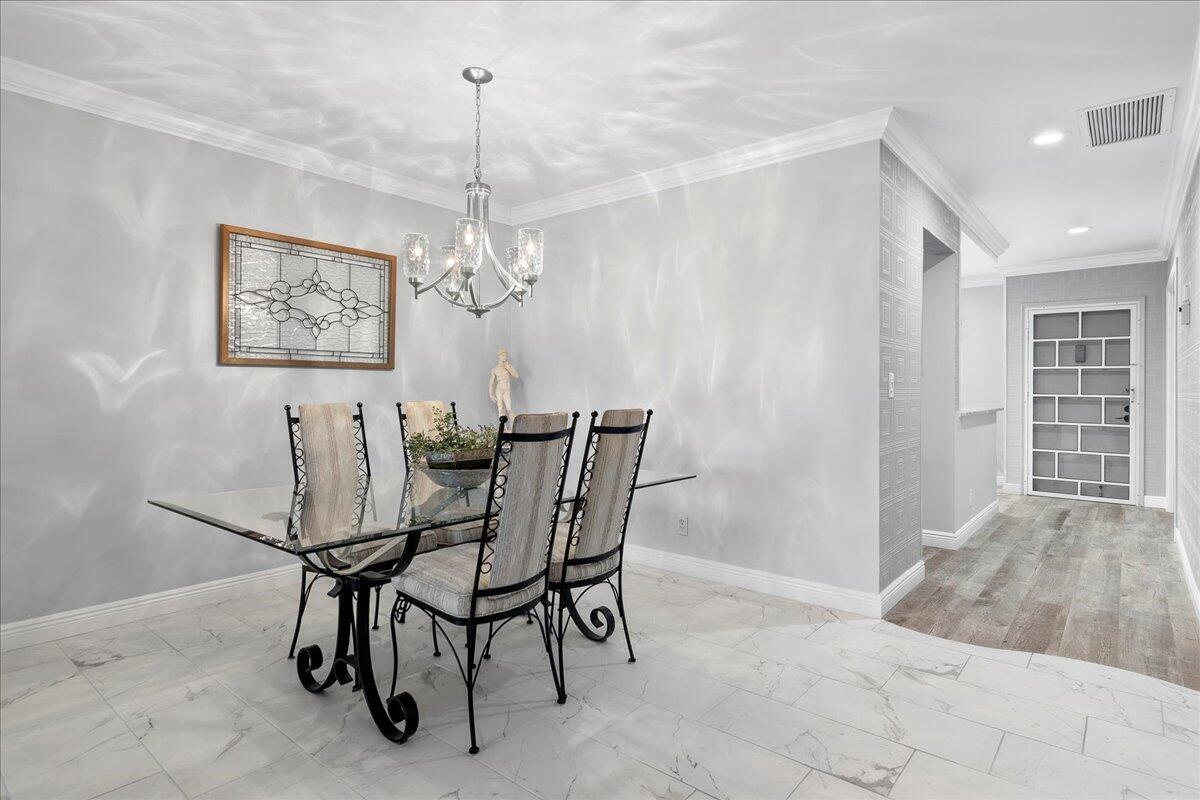1395 Southwest 27th Avenue, Unit 103 Delray Beach, FL 33445 - Photo 16 of 26 a view of a dining room with furniture