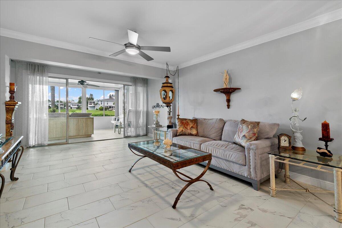 1395 Southwest 27th Avenue, Unit 103 Delray Beach, FL 33445 - Photo 18 of 26 a living room with furniture and a kitchen