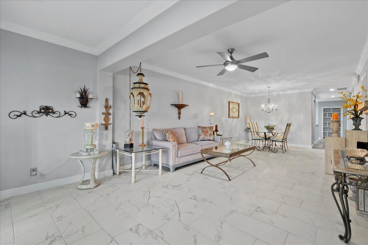 1395 Southwest 27th Avenue, Unit 103 Delray Beach, FL 33445 - Photo 19 of 26 a living room with furniture and white walls