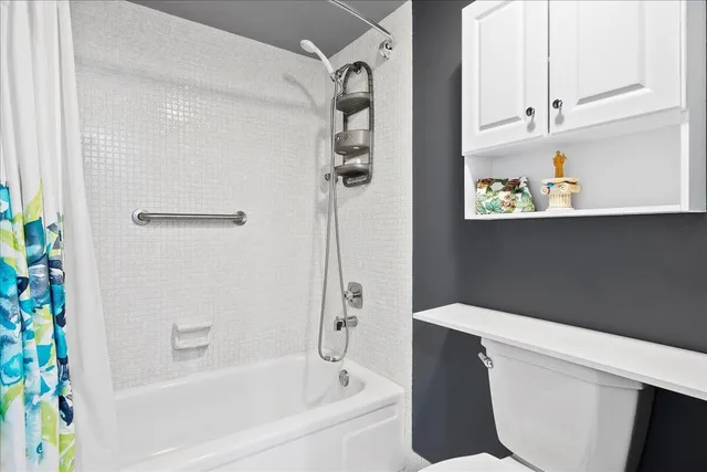 a bathroom with a bathtub and shower