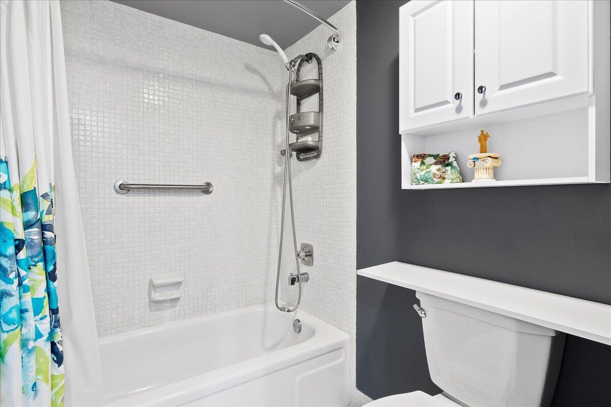 1395 Southwest 27th Avenue, Unit 103 Delray Beach, FL 33445 - Photo 25 of 26 a bathroom with a bathtub and shower