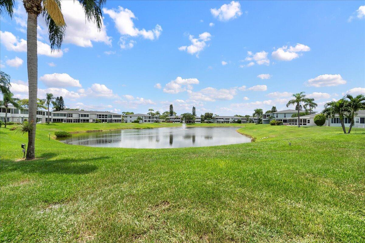 1395 Southwest 27th Avenue, Unit 103 Delray Beach, FL 33445 - Photo 4 of 26 a view of a lake with houses in the back