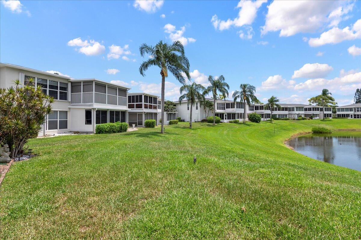 1395 Southwest 27th Avenue, Unit 103 Delray Beach, FL 33445 - Photo 5 of 26 a view of a house with a yard and sitting area