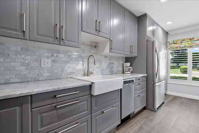 a kitchen with stainless steel appliances granite countertop a sink stove and cabinets