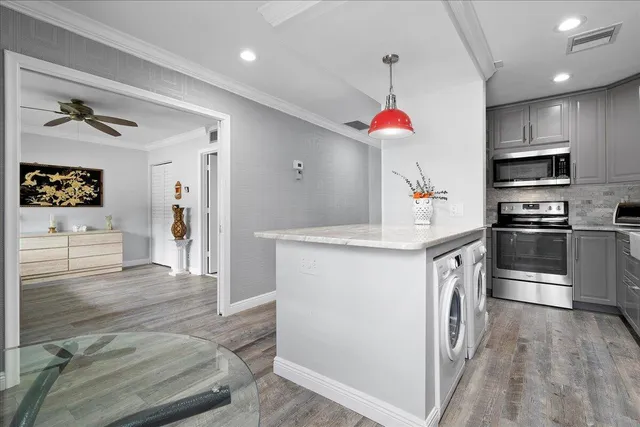 a kitchen with granite countertop a refrigerator and a sink