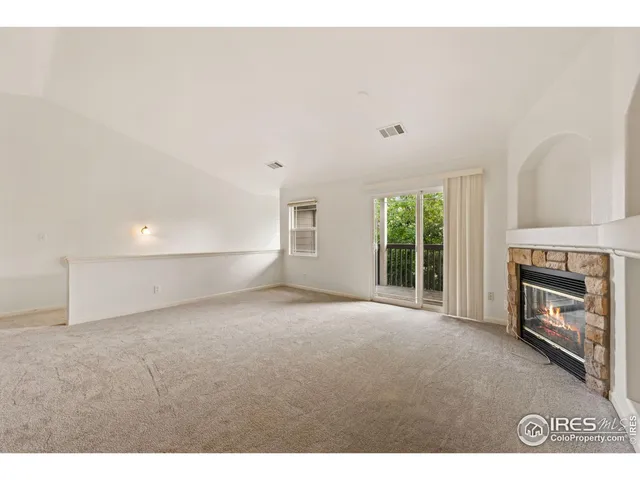 a view of empty room with a fireplace