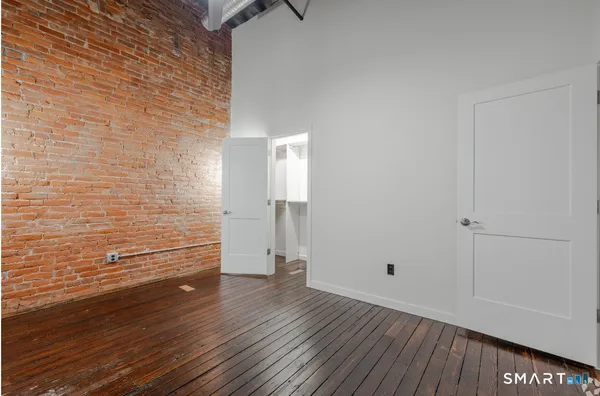 a view of walk in closet with empty racks