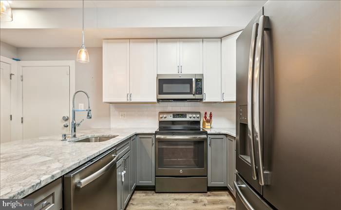 1340 Nicholson Street Northwest, Unit 2 Washington, DC 20011 - Photo 3 of 16 a kitchen with a sink stove and refrigerator