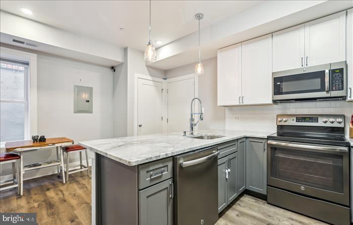 1340 Nicholson Street Northwest, Unit 2 Washington, DC 20011 - Photo 5 of 16 a kitchen with a sink stove and microwave