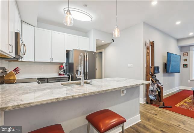 1340 Nicholson Street Northwest, Unit 2 Washington, DC 20011 - Photo 7 of 16 a kitchen with stainless steel appliances granite countertop a sink refrigerator and microwave