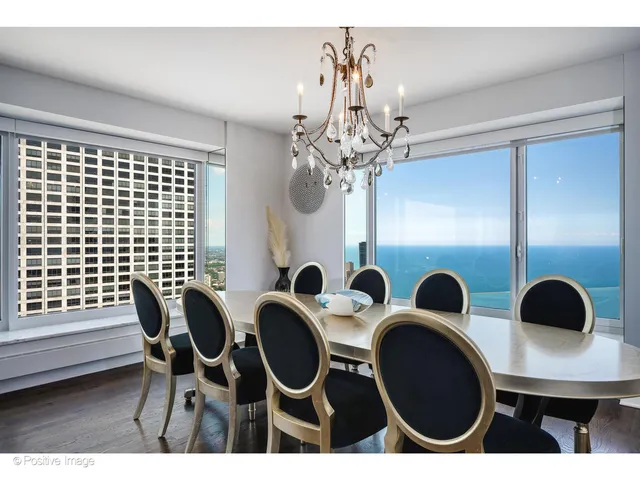 a view of a dining room with furniture and chandelier